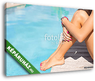 Woman sitting on the deck by the swimming pool - vászonkép 3D látványterv