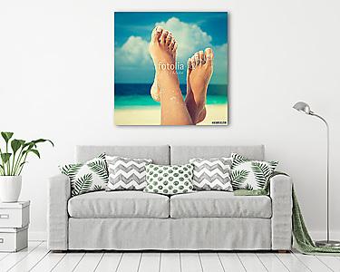 Tanned well-groomed feet amid tropical turquoise sea
 (vászonkép) - vászonkép, falikép otthonra és irodába