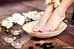 Closeup photo of a female feet at spa salon on pedicure procedur vászonkép, poszter vagy falikép
