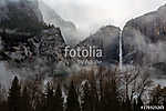 A fog rolls over Upper Yosemite Falls in Yosemite National Park, vászonkép, poszter vagy falikép