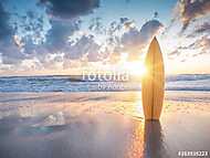 Surfboard on the beach at sunset vászonkép, poszter vagy falikép