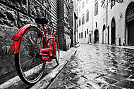 Retro piros bicikli a macskaköves utcán vászonkép, poszter vagy falikép