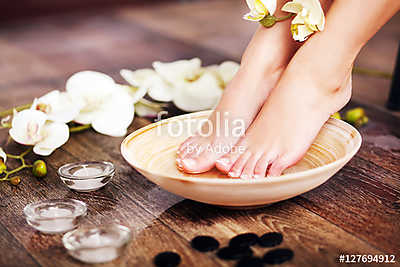 Closeup photo of a female feet at spa salon on pedicure procedur (poszter) - vászonkép, falikép otthonra és irodába
