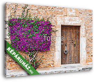 Old wooden door and stone wall with mediterranean bougainvillea - vászonkép 3D látványterv