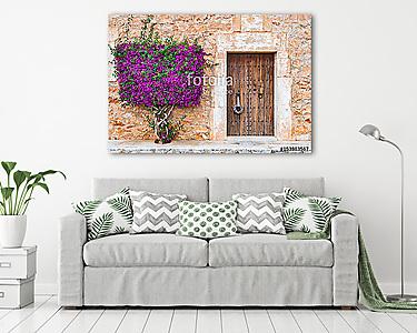 Old wooden door and stone wall with mediterranean bougainvillea (vászonkép) - vászonkép, falikép otthonra és irodába