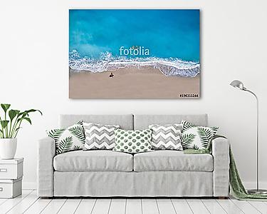 Top view of a woman at the tropical beach relaxing on the sand (vászonkép) - vászonkép, falikép otthonra és irodába