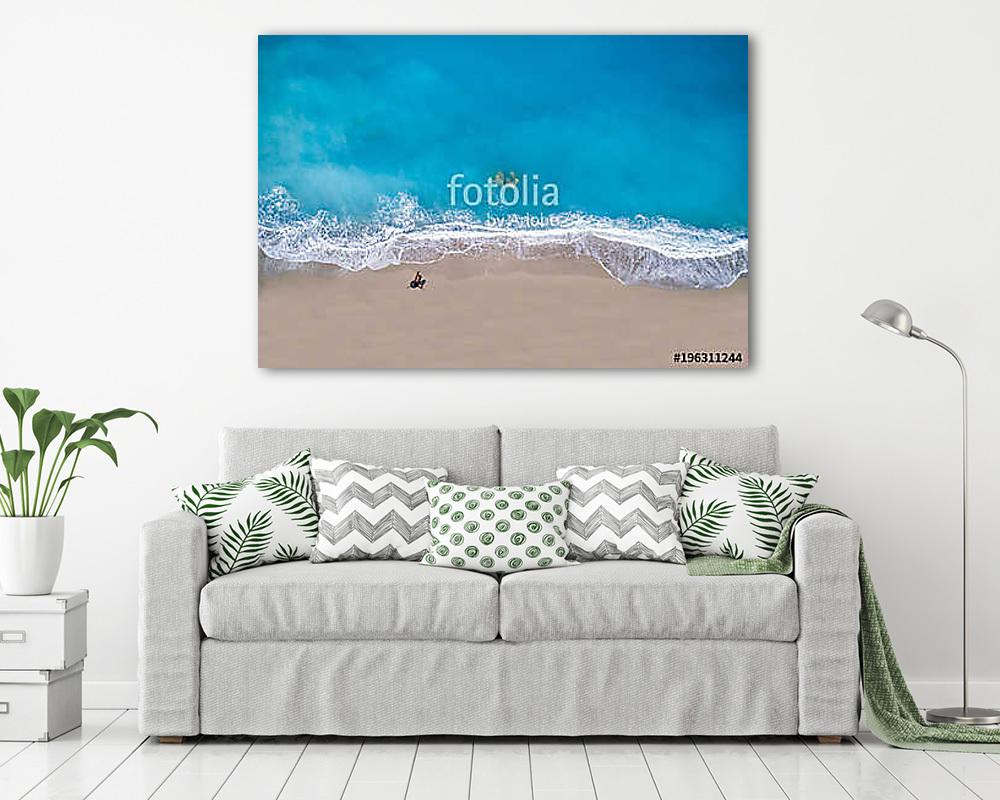 Top view of a woman at the tropical beach relaxing on the sand - vászonkép, falikép vásárlás Top view of a woman at the tropical beach relaxing on the sand (vászonkép) - vászonkép, falikép otthonra és irodába