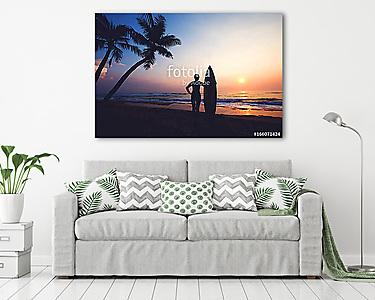 Silhouette women surfer on tropical beach at sunset. landscape of summer beach and palm tree at sunset. vintage color tone (vászonkép) - vászonkép, falikép otthonra és irodába
