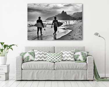 Scenic black and white view of Rio de Janeiro, Brazil with Brazilian surfers walking along the shore of Ipanema Beach (vászonkép) - vászonkép, falikép otthonra és irodába