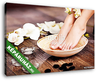 Closeup photo of a female feet at spa salon on pedicure procedur - vászonkép 3D látványterv