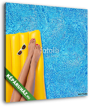 Woman relaxing in a pool - feet close up - vászonkép 3D látványterv
