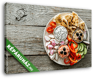 Selection of traditional greek food - salad, meze, pie, fish, tzatziki, dolma on wood background, top view - vászonkép 3D látványterv