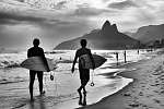 Scenic black and white view of Rio de Janeiro, Brazil with Brazilian surfers walking along the shore of Ipanema Beach vászonkép, poszter vagy falikép