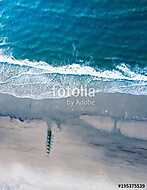 Wooden dock on a empty beach aerial vászonkép, poszter vagy falikép