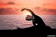 Silhouette of a girl practicing yoga vászonkép, poszter vagy falikép