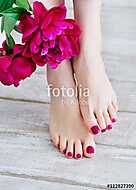 Feet with pink pedicure and peonies vászonkép, poszter vagy falikép