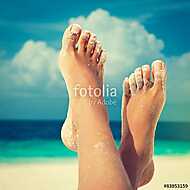 Tanned well-groomed feet amid tropical turquoise sea vászonkép, poszter vagy falikép