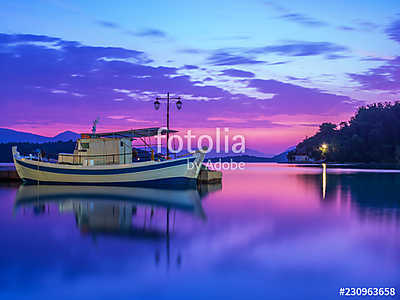 Fishing boat at Sunrise on the bay of Nidri in Lefkas island Greece (vászonkép óra) - vászonkép, falikép otthonra és irodába