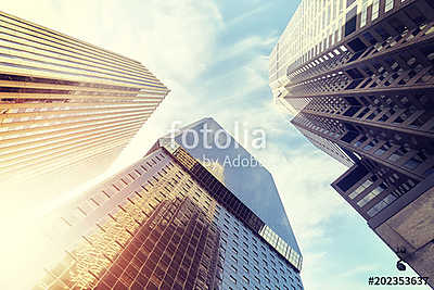 Looking up at Denver skyscrapers at sunset, color toned picture, (keretezett kép) - vászonkép, falikép otthonra és irodába