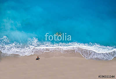 Top view of a woman at the tropical beach relaxing on the sand (poszter) - vászonkép, falikép otthonra és irodába