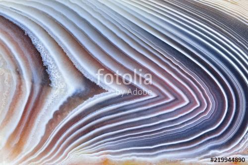 Amazing Banded Agate Crystal cross section as a background. Natural light translucent agate crystal surface, Gray abstract expre, Premium Kollekció