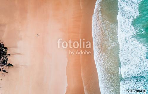 Aerial view of a surfer coming out of the water on a beach in Asturias, Premium Kollekció
