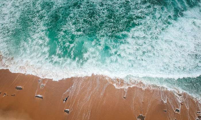 surfer on the beach top view. Drone shot on a beach in a summer day., Premium Kollekció