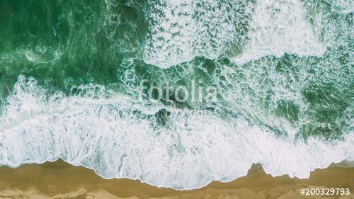 Waves near beach. Yellow sand and green water, Premium Kollekció