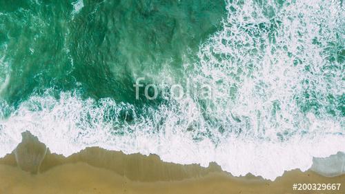 Waves near beach. Yellow sand and green water, Premium Kollekció